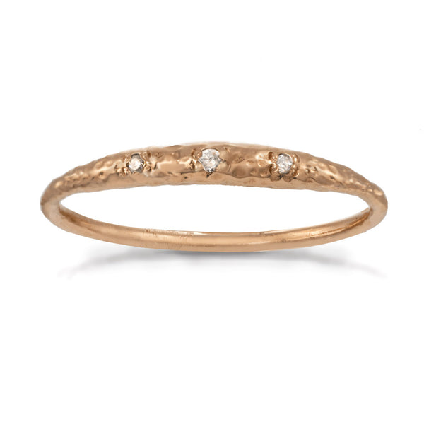 Thin rose gold band with tiny crescent shaped diamonds in the front.