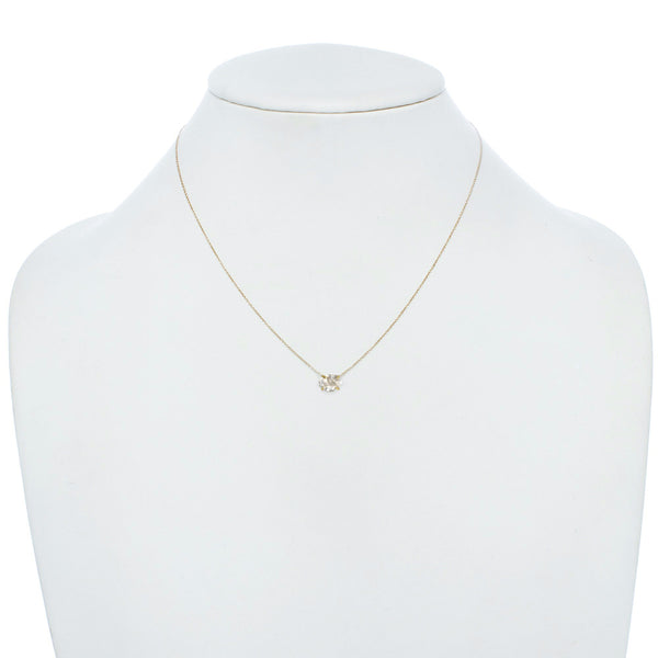Delicate Herkimer Crystal pendant necklace with a gold chain on jewelry display.