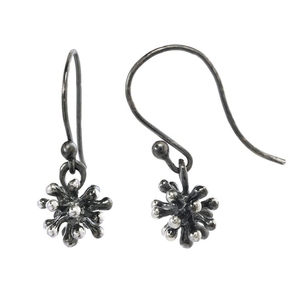 Dangling dandelion earrings on an oxidized silver fishhook. 