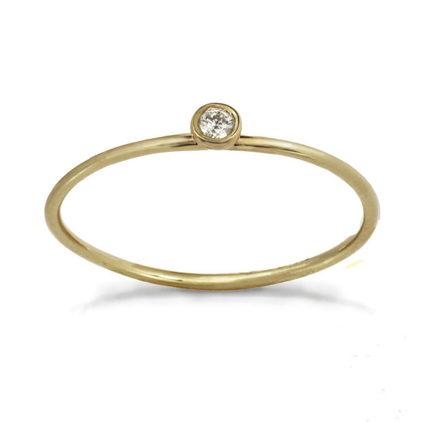 Delicate yellow gold ring with center white diamond stone.