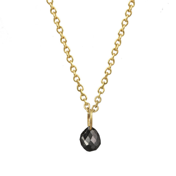 Tiny Constellation drop necklace with small black diamond on a gold chain.