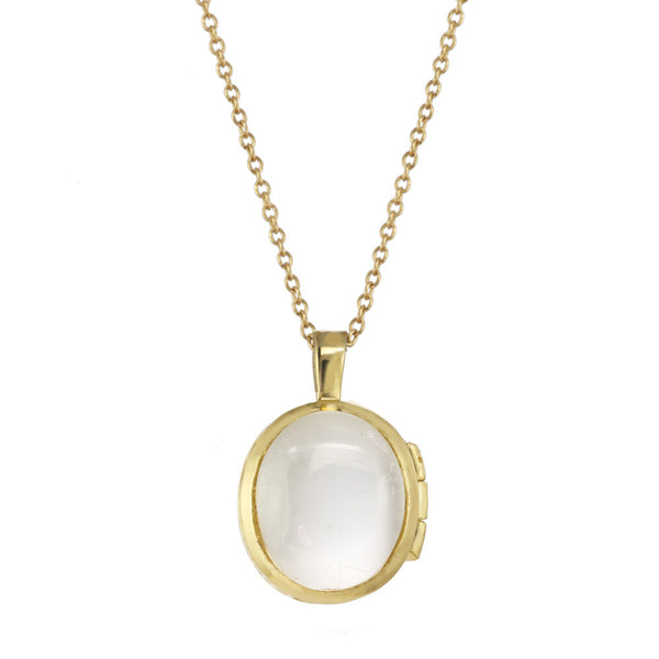 Gold locket with a Herkimer crystal on a gold chain.