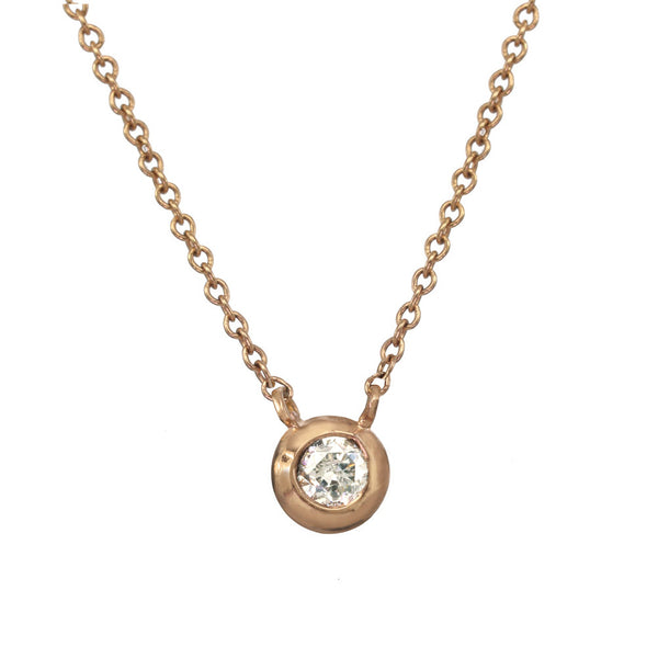 Rose gold pendant necklace with a white or champagne diamond.