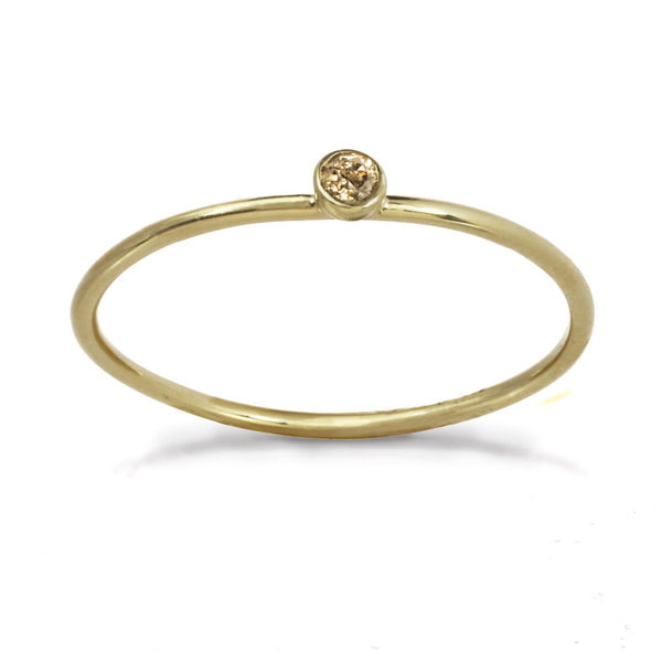 Delicate gold ring with champagne diamond stone.