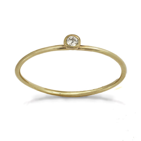 Delicate yellow gold ring with center white diamond stone.