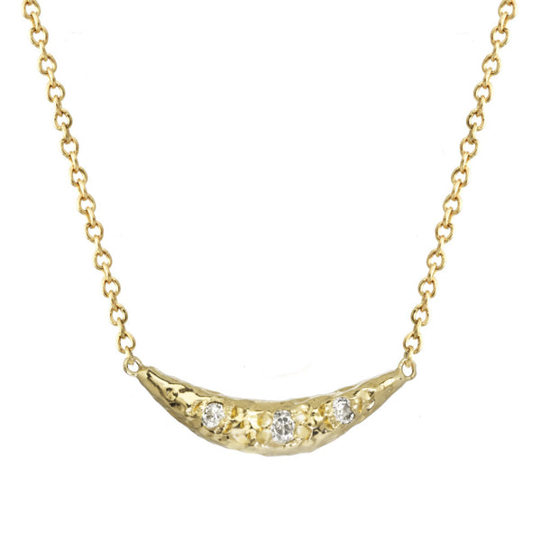 Crescent moon half moon pendant necklace with white diamonds on a yellow gold chain.