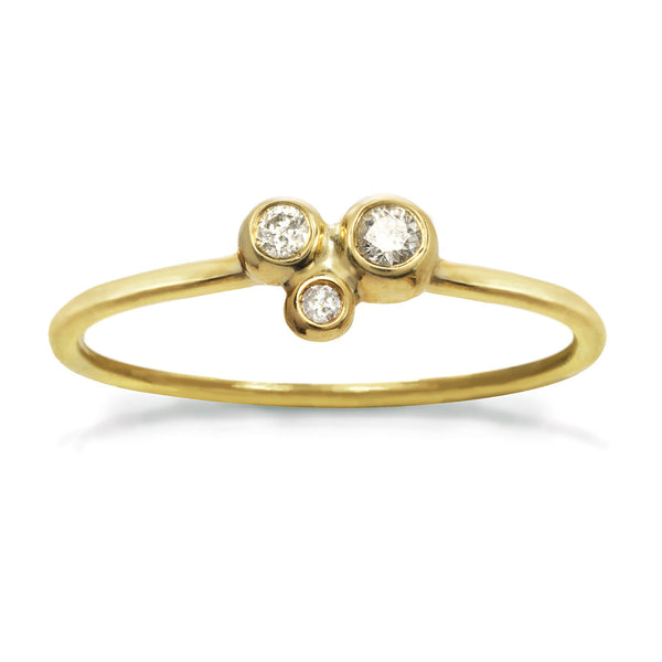 Delicate gold ring with three small diamonds in a constellation shape.